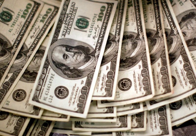 Dollar teeters discontinuance to one-year low; euro climbs to 17-month peak